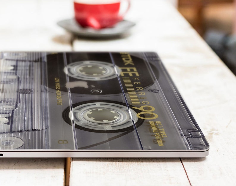 May include: A black and silver cassette tape with the text "STK EE FERIC 90" printed on the label. The tape is labeled "BEST TYPE I NORMAL POSITION" and "LOW NOISE HIGH OUTPUT".