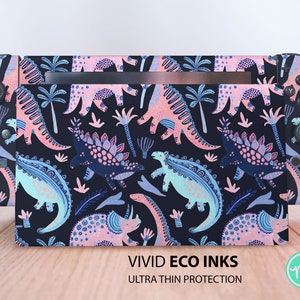 May include: A Nintendo Switch console skin featuring a colourful dinosaur pattern on a black background. The skin is designed to fit the console and controllers. The skin is made with vivid eco inks and provides ultra thin protection.