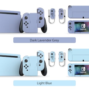 May include: Two Nintendo Switch consoles with different colored skins. The top console is a dark lavender grey and the bottom console is a light blue. Both consoles have black Joy-Cons and a Nintendo Switch logo on the screen.