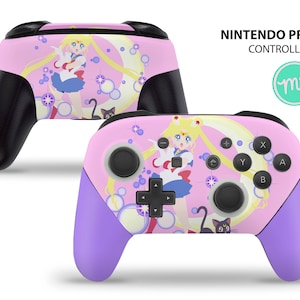 May include: Pink Nintendo Pro Controller featuring a Sailor Moon design. The controller has black grips, purple handles, and a colorful illustration of the anime character. The text "NINTENDO PRO CONTROLLER" is visible.