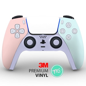 May include: A white PlayStation 5 DualSense controller with a pink and light blue custom skin. The skin is made with 3M premium vinyl and has the text "ms" in a circle on the bottom.