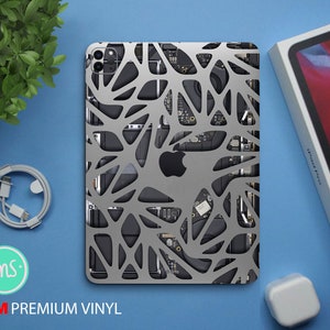 May include: A gray and black patterned vinyl skin for an iPad Pro. The skin features a geometric design with a 3M logo and the words "Premium Vinyl".