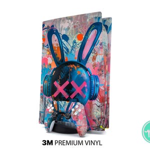 May include: A colorful vinyl skin for a gaming console, featuring a graffiti-style design. The artwork includes a bunny head with headphones and pink cross-shaped eyes, along with a matching controller. The background is a mix of vibrant colors.