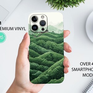 May include: A green and white phone case with a landscape design. The case features a 3M premium vinyl sticker with a green and white landscape design. The case is compatible with over 400 smartphone models.