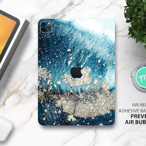 May include: A blue and gold abstract design phone case with a white background. The case has a gold glitter effect and the text "AIR-RELEASE ADHESIVE BACKING PREVENTS AIR BUBBLES".