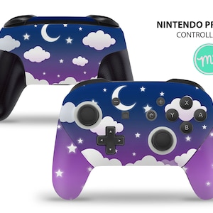 Puede incluir: Un mando Nintendo Pro de color morado y azul con un diseño de cielo nocturno estrellado. El mando presenta una luna creciente, nubes y estrellas.