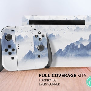 May include: A white Nintendo Switch console and Joy-Con controllers with a blue and white mountain landscape design. The text "FULL-COVERAGE KITS FOR PROTECT EVERY CORNER" is printed below the console.