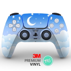 May include: A blue and white PlayStation 5 controller with a moon and stars design. The controller has a 3M logo and the text "PREMIUM VINYL" on the bottom.