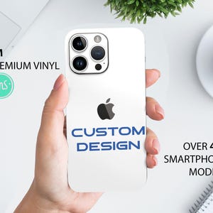 May include: White phone case with a blue "CUSTOM DESIGN" text and an apple logo. 3M Premium Vinyl.