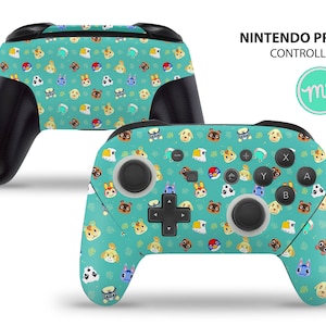May include: A green and black Nintendo Pro Controller with a custom design featuring characters from the Animal Crossing video game series. The controller has a blue and white button layout and a green and white design with animal faces.