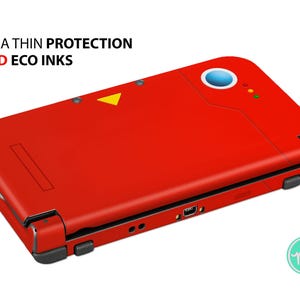 May include: Red Nintendo 3DS XL console skin with a yellow triangle and the words "ULTRA THIN PROTECTION VIVID ECO INKS" printed on the top.
