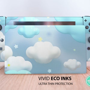 May include: A light blue Nintendo Switch console skin with a white cloud and star pattern. The skin is labeled "VIVID ECO INKS ULTRA THIN PROTECTION".