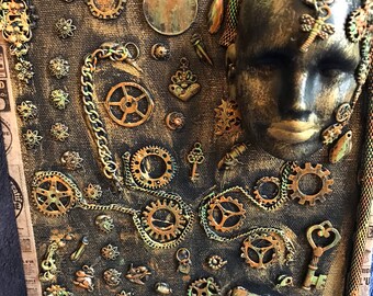 May include: A mixed media art piece with a steampunk theme. The piece features a human face with gears, keys, and other metal objects attached to it. The background is a dark brown canvas with a newspaper print.