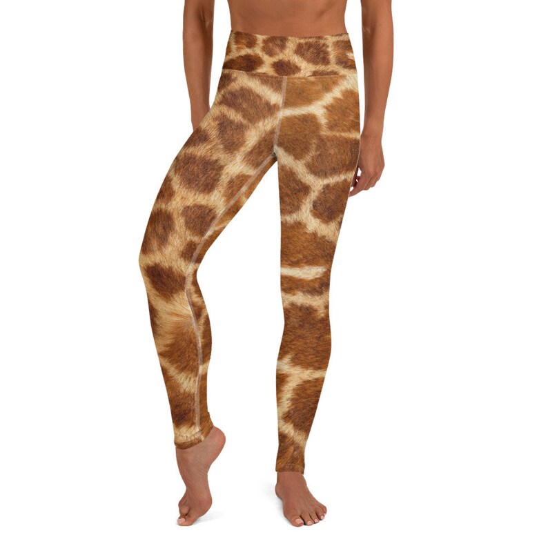 May include: High-waisted yoga leggings with a giraffe print. The leggings feature a brown and tan pattern, mimicking the natural markings of a giraffe. The leggings are designed for comfort and flexibility, suitable for various activities.