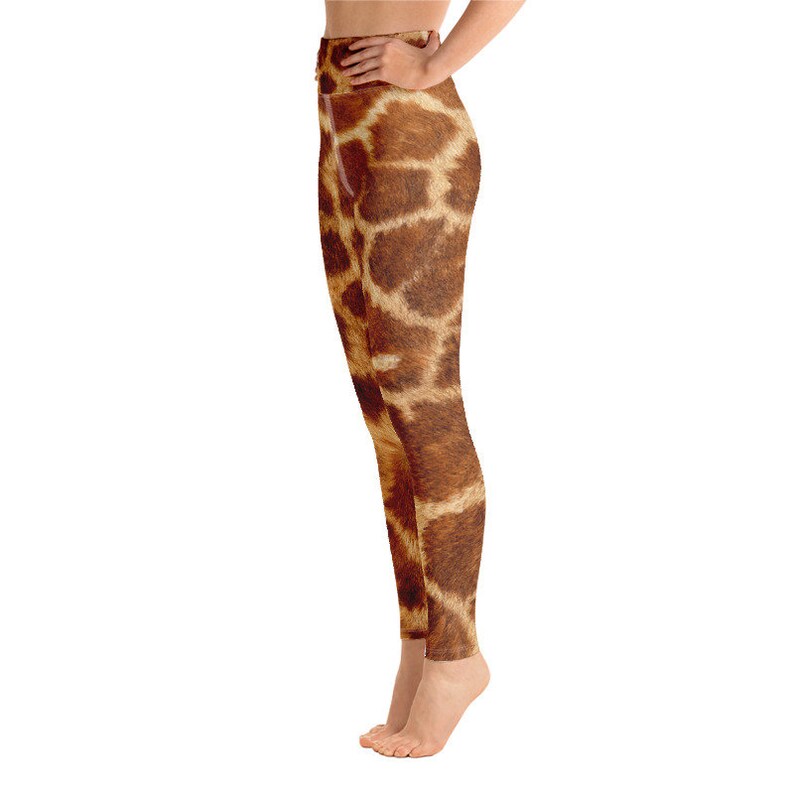 May include: High-waisted leggings with a giraffe print. The leggings feature a brown and tan pattern, mimicking the markings of a giraffe. The fabric appears to be smooth and form-fitting, suitable for athletic activities or casual wear.