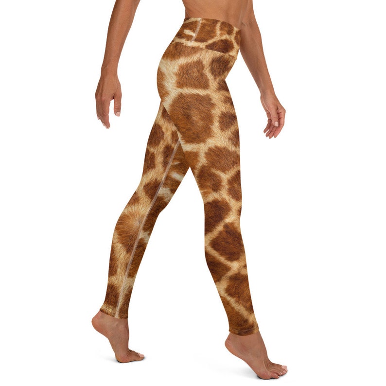 May include: High-waisted leggings with a giraffe print. The leggings feature a brown and tan pattern, mimicking the markings of a giraffe. The fabric appears to be soft and stretchy, suitable for yoga or other activities.