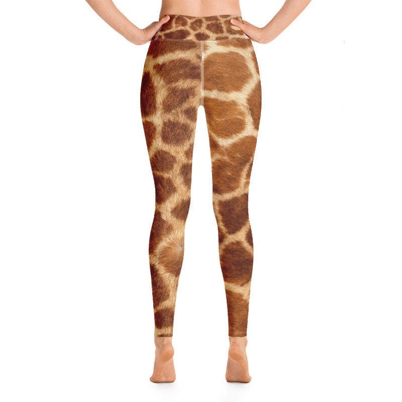 May include: A pair of leggings with a giraffe print. The leggings are brown and tan with a repeating pattern that mimics the markings of a giraffe. The leggings are form-fitting and reach the ankles.