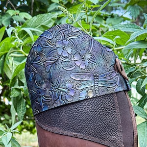 May include: Brown leather riding boots with a decorative top featuring a floral and dragonfly design in shades of blue and purple. The boots have a tall shaft and a textured leather panel on the lower portion.