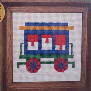 May include: Needlepoint kit featuring a colorful design of a vintage parlor car. The kit includes 100% cotton canvas, 100% wool yarn, a needle, mounting board, and instructions. The kit also includes a frame offer.
