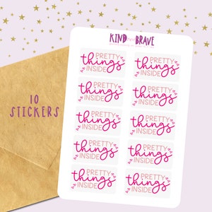 May include: Ten white stickers with pink lettering that reads "PRETTY THINGS INSIDE" with small hearts around the text. The stickers are arranged in two rows of five.