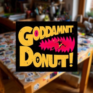 May include: Square black graphic with yellow text that reads "GODDAMNIT DONUT!" with a pink jagged mouth design. A person and dog are running away from the mouth. A trophy and pineapple are at the bottom.