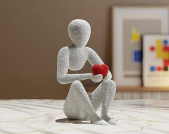 Escultura minimalista: Figura de abrazo de amor con corazón rojo