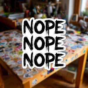 May include: A white die-cut sticker featuring the word NOPE printed three times in a stacked vertical arrangement. The text is rendered in a bold, black, distressed brushstroke font with a rough, textured appearance on a clean white background.