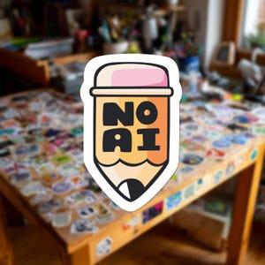 May include: A die-cut sticker shaped like a yellow pencil with a pink eraser at the top. The pencil body features the bold black text NO AI stacked in the center. The tip of the pencil is black and white, outlined in a thick white border.