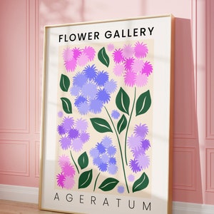May include: A poster with the title "FLOWER GALLERY" and the text "AGERATUM" at the bottom. The poster features a stylized illustration of purple and pink flowers with green leaves on a cream background.