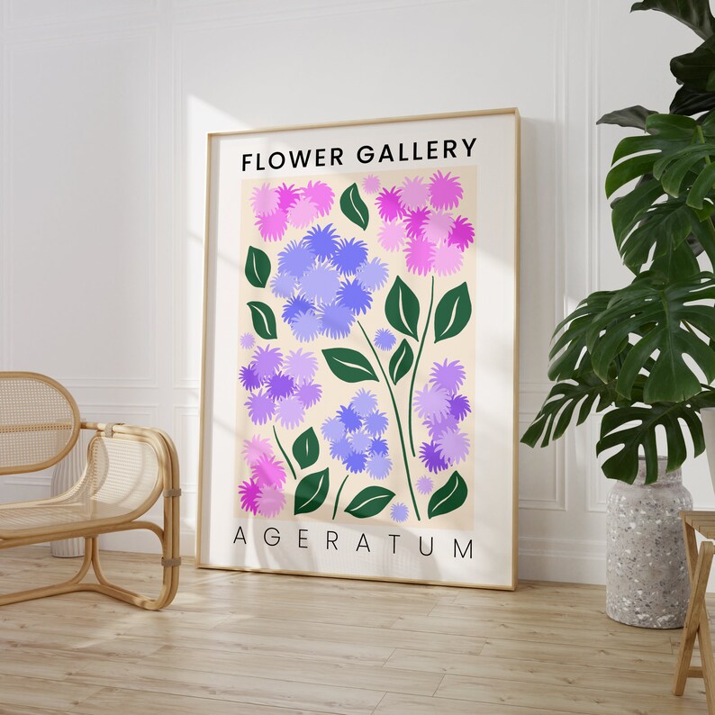 May include: A poster with the title "FLOWER GALLERY" and the text "AGERATUM" at the bottom. The poster features a stylized illustration of purple and pink flowers with green stems on a cream background.