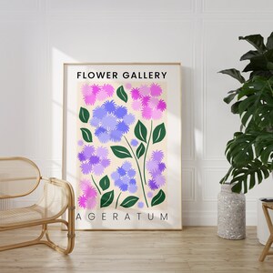 May include: A poster with a floral design featuring purple and pink flowers with green stems. The poster has the text "FLOWER GALLERY" and "AGERATUM" printed on it.