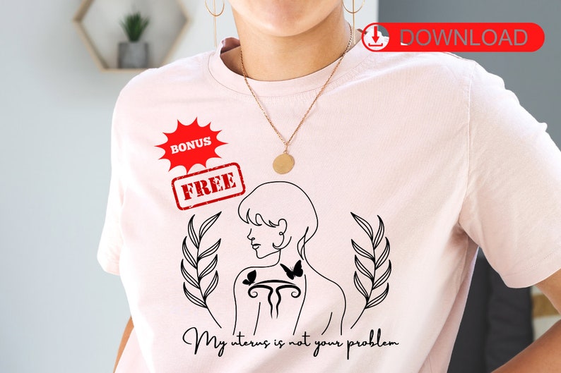 May include: A pink t-shirt with a black line drawing of a woman with a uterus symbol and butterflies on her back. The text "My uterus is not your problem" is printed below the drawing.