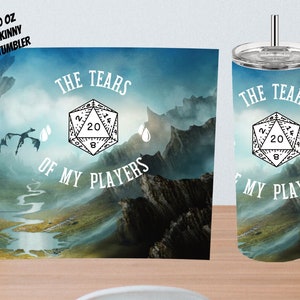 May include: A 20 ounce skinny tumbler with a blue and white design featuring a 20-sided die and the text "The Tears of My Players".