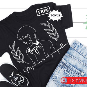 May include: Black t-shirt with a white line drawing of a woman with a butterfly on her back and the text "My uterus is not your problem".
