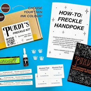 May include: A brown cardboard box with the words "Purdy's Freckle Kit" printed on it. The box contains a small bottle of ink, four small plastic cups, and three pre-made tattoo needles. The box is sitting on a blue surface. There is a guide to handpoke tattooing with the words "Purdy's The Ultimate Guide to Handpoke Tattooing" printed on it. There are also two alcohol pads.