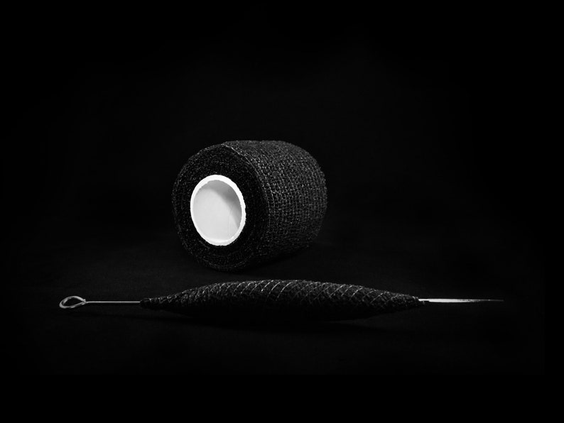 May include: A roll of black athletic tape and a black metal tool with a loop at one end.