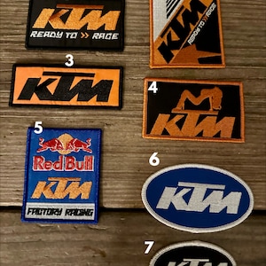 May include: Seven different embroidered patches featuring the KTM logo in various colors and designs. The patches include the text "Ready to Race" and "Factory Racing".