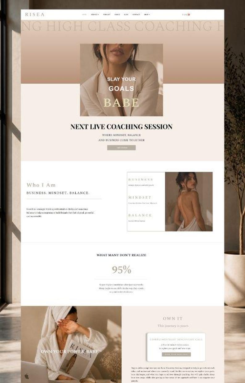 May include: Website design with a neutral color palette, featuring text that reads "SLAY YOUR GOALS BABE" and "NEXT LIVE COACHING SESSION." The site promotes business, mindset, and balance. A woman is shown in a white robe.