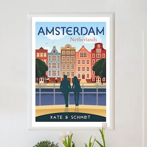 May include: A colorful illustration of Amsterdam, Netherlands, with a couple walking hand-in-hand in front of traditional canal houses. The text "AMSTERDAM" and "Netherlands" is at the top of the image. The text "KATE & SCHMIDT" is at the bottom of the image.