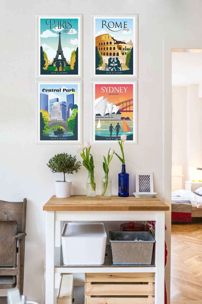May include: Four framed travel posters with a vintage aesthetic. The posters feature illustrations of the Eiffel Tower in Paris, the Colosseum in Rome, Central Park in New York City, and the Sydney Opera House in Sydney, Australia. Each poster has the city name and location at the top, and the text "KATE & SCHMIDT" at the bottom.