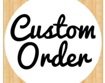 May include: A white circle with a black background on a woodgrain surface. The text "Custom Order" is written in a black cursive font.