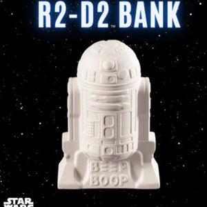 May include: White ceramic R2-D2 piggy bank with the words "Beep Boop" on the base. Star Wars logo is visible in the bottom left corner.