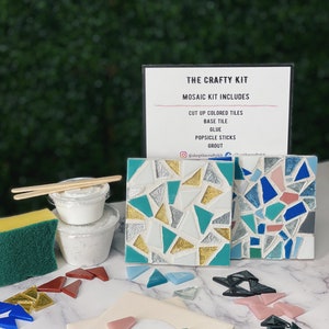 May include: A mosaic craft kit with all the supplies needed to create a mosaic art project. The kit includes a base tile, cut up colored tiles, glue, popsicle sticks, and grout. The kit is displayed on a white surface with a green background.