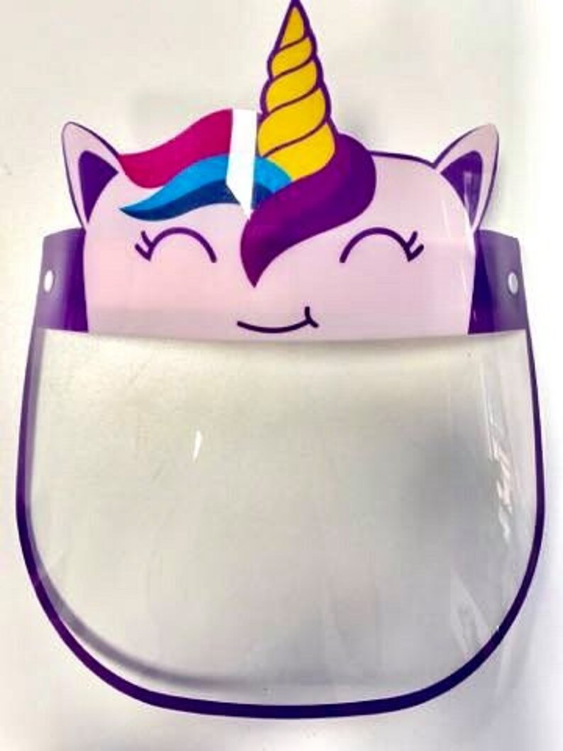 May include: Purple and pink unicorn face design on a clear plastic face shield with a purple border.