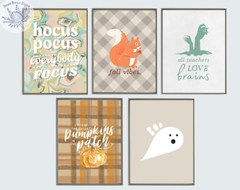 May include: Set of five printable Halloween and fall-themed illustrations. The illustrations feature a ghost, a squirrel, a pumpkin, a hand with the text "all teachers love brains", and a marbled background with the text "hocus pocus everybody focus".