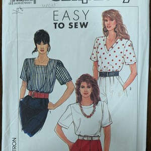 May include: Simplicity sewing pattern U5 (sizes 16-24) featuring three different top and skirt designs. The pattern includes a striped top, a polka dot top, and a plain white top. The text "EASY TO SEW" is displayed prominently.