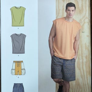 May include: Simplicity sewing pattern S9314 featuring sleeveless tops and shorts. The pattern includes illustrations of the garments in various colors and styles. The model is wearing an orange sleeveless top and patterned shorts.