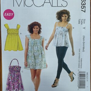 May include: McCall's M6357 sewing pattern envelope featuring illustrations and photographs of sleeveless tops and dresses with square necklines and gathered bodices. The pattern includes options for solid yellow, floral print, and purple patterned garments.