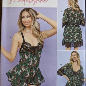 May include: Simplicity sewing pattern S9802 for a Madalynne sleepwear set. The pattern includes a short, green floral print slip with black lace trim and a matching robe with long sleeves and a tie closure. The pattern is for sizes 1X-5X.