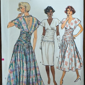 May include: Vogue Patterns sewing pattern envelope featuring illustrations of three dresses. The dresses include a plaid, a white, and a floral design. The envelope includes the pattern number 9550 and size range (6-8-10).